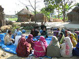 © 2008 Meenakshi Dikshit & Neeraj Upreti, Courtesy of Photoshare. Women and men participate in a village level meeting in India.
